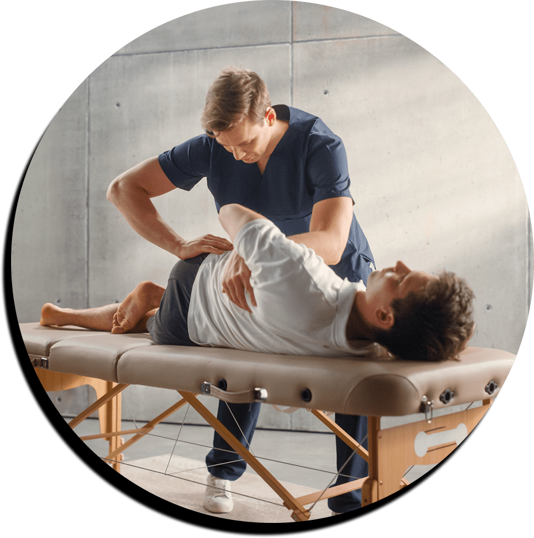 Therapist treating patient on massage table